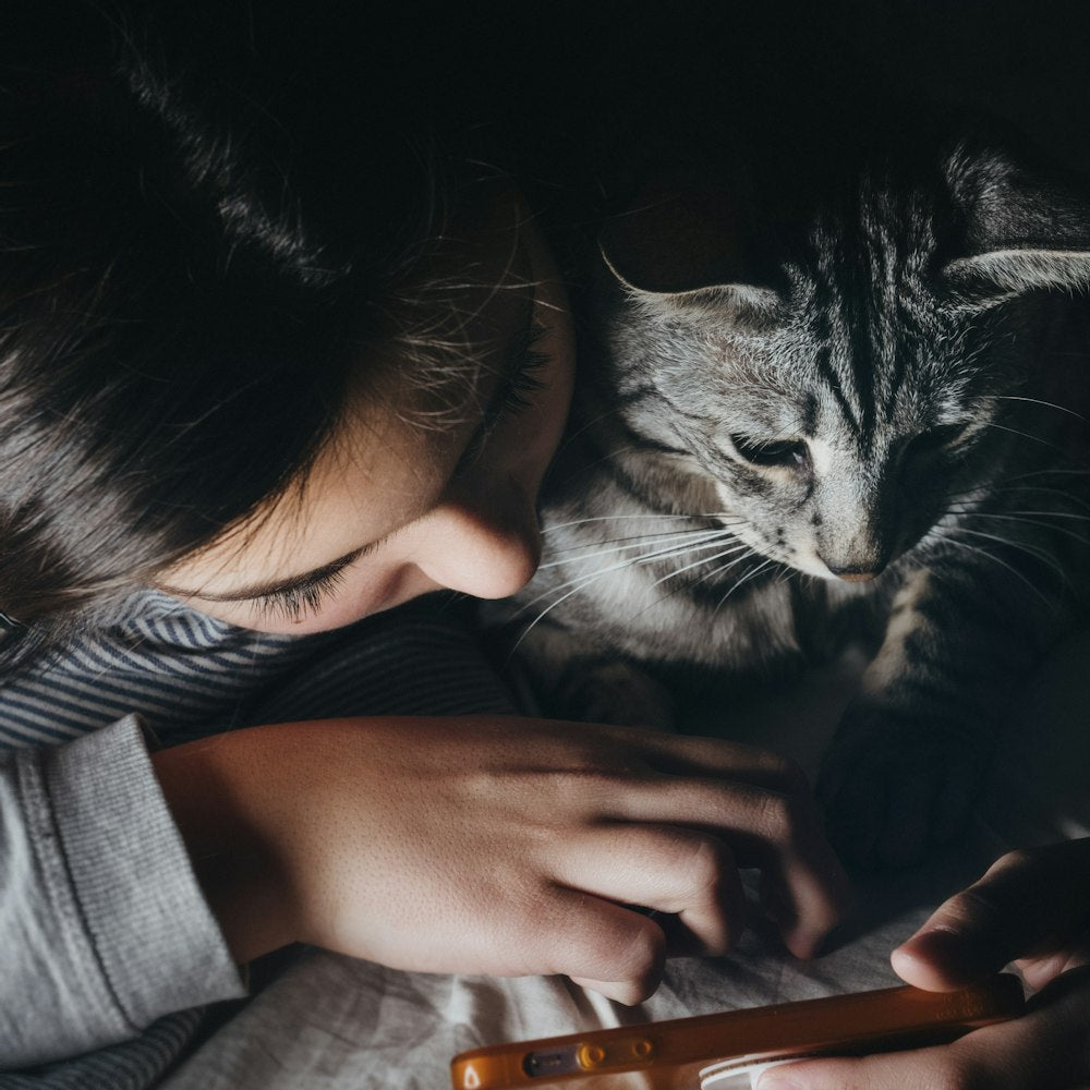 Woman and tabby cat sharing a quiet moment