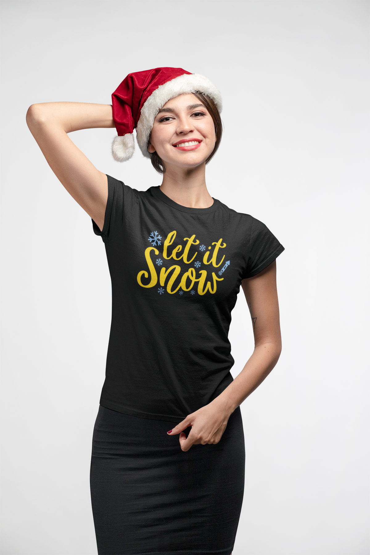 Woman in a Santa hat wearing the Let It Snow black t-shirt