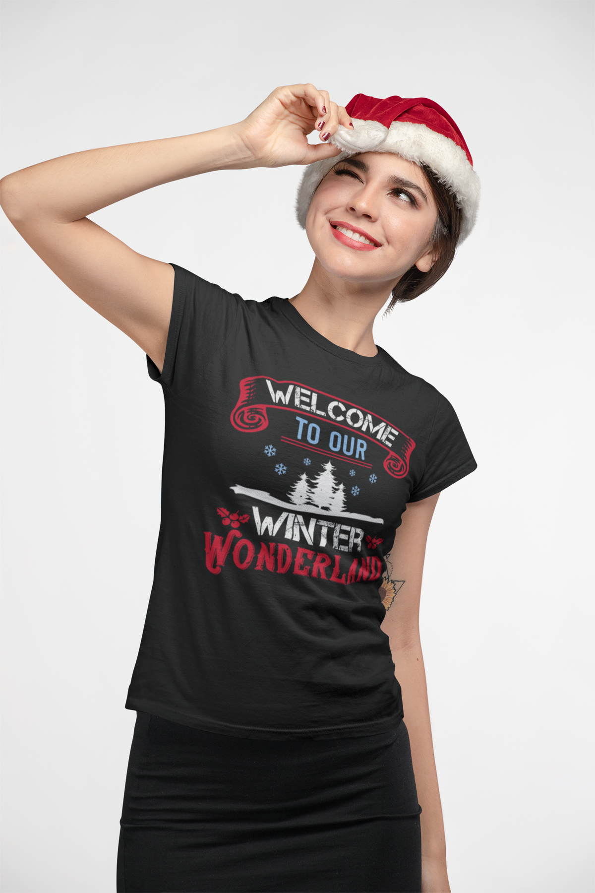 Woman in a Santa hat wearing the Welcome to Our Winter Wonderland black t-shirt