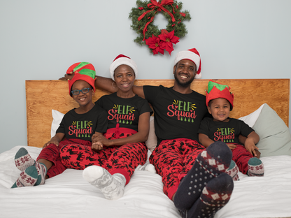 Family in matching black Elf Squad Christmas tees in bed