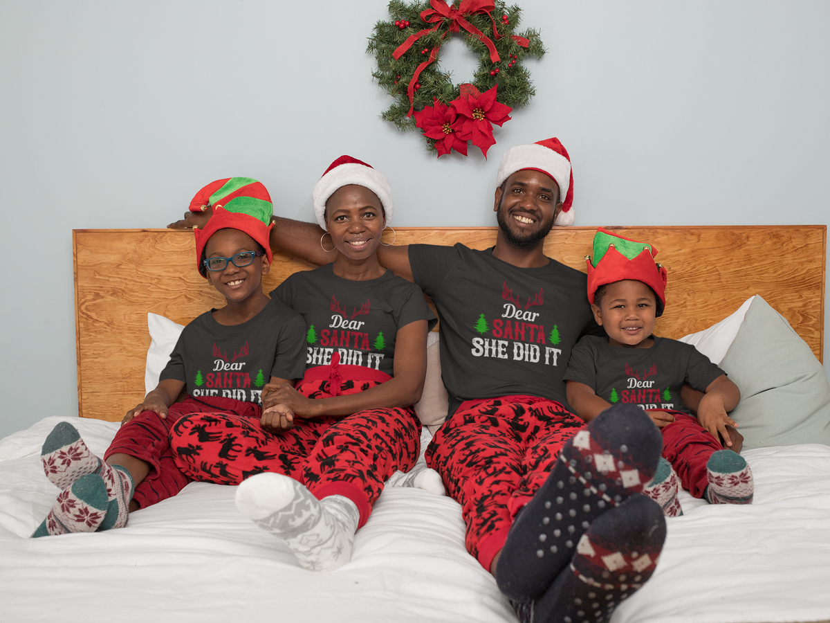 Matching family wearing Dear Santa, She Did It Christmas shirts