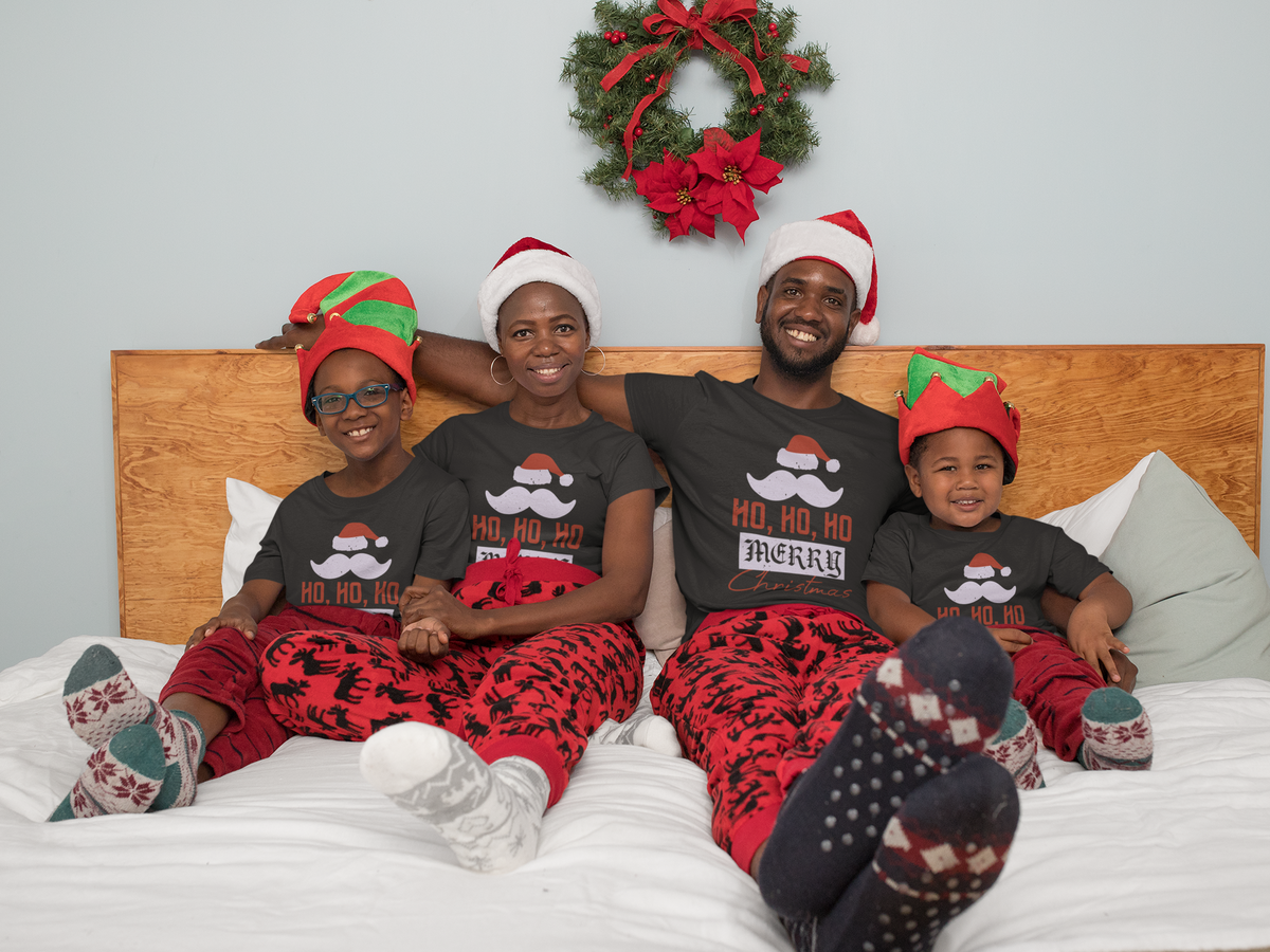 Matching family wearing Ho Ho Ho Merry Christmas shirts