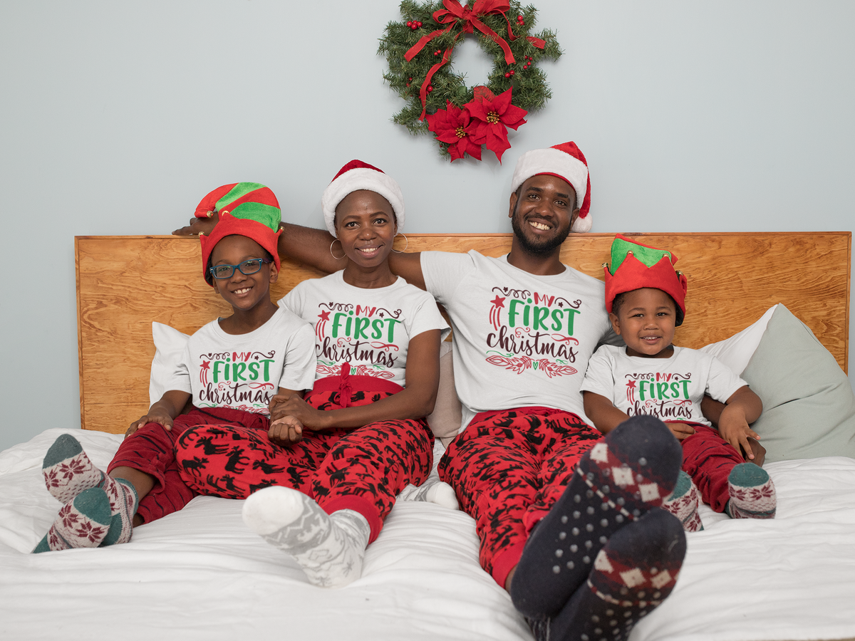 Matching family wearing My First Christmas shirts