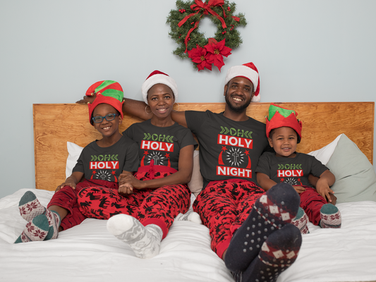 Matching family wearing O Holy Night Christmas shirts