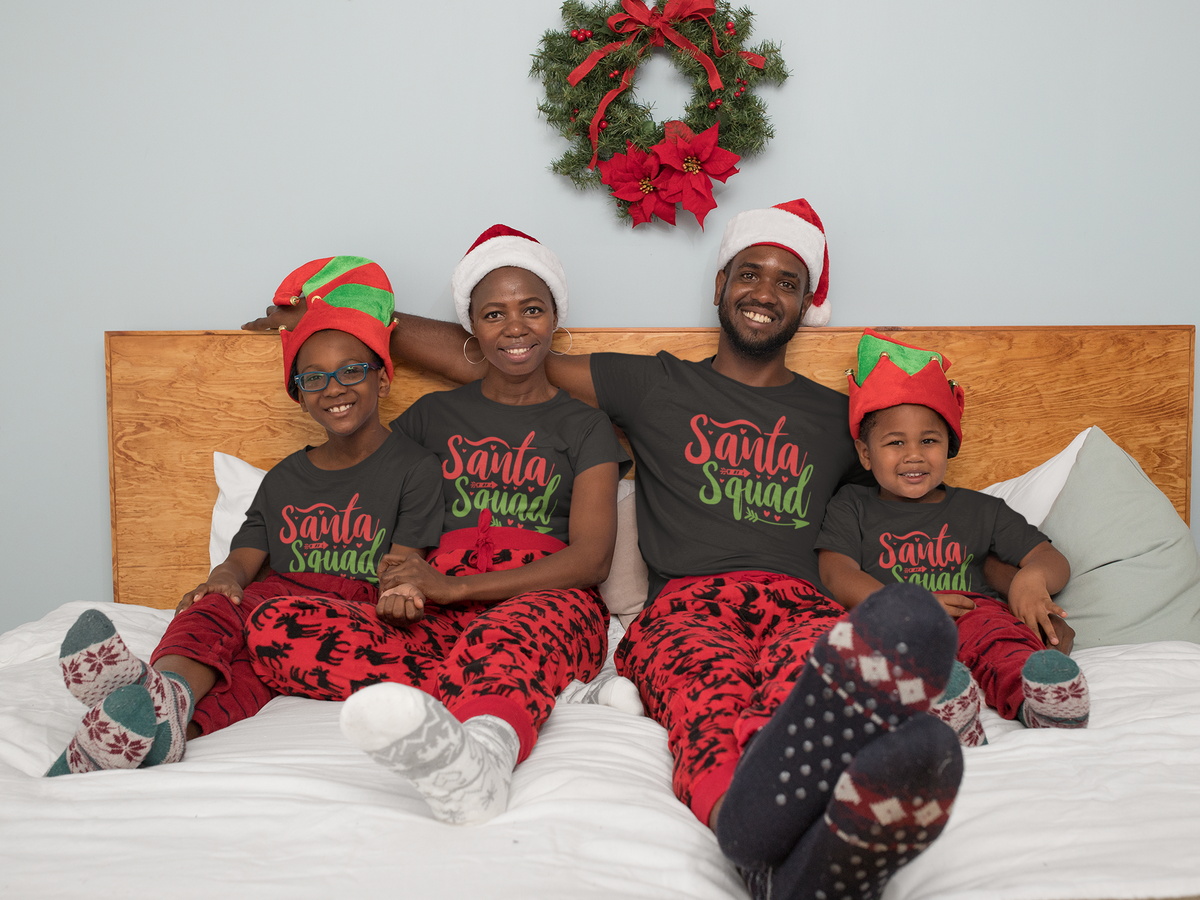 Matching family wearing Santa Squad Christmas shirts