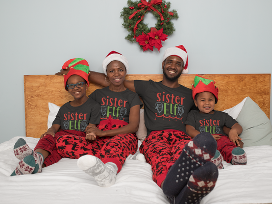 Matching family wearing Sister Elf Christmas shirts