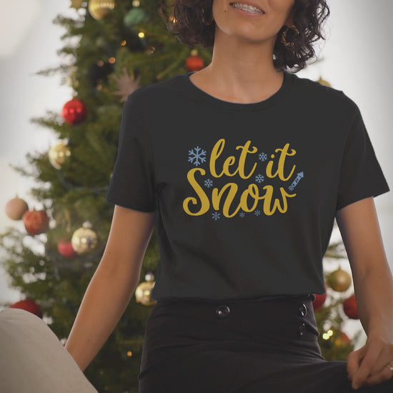 Video of a woman wearing the Let It Snow black Christmas t-shirt