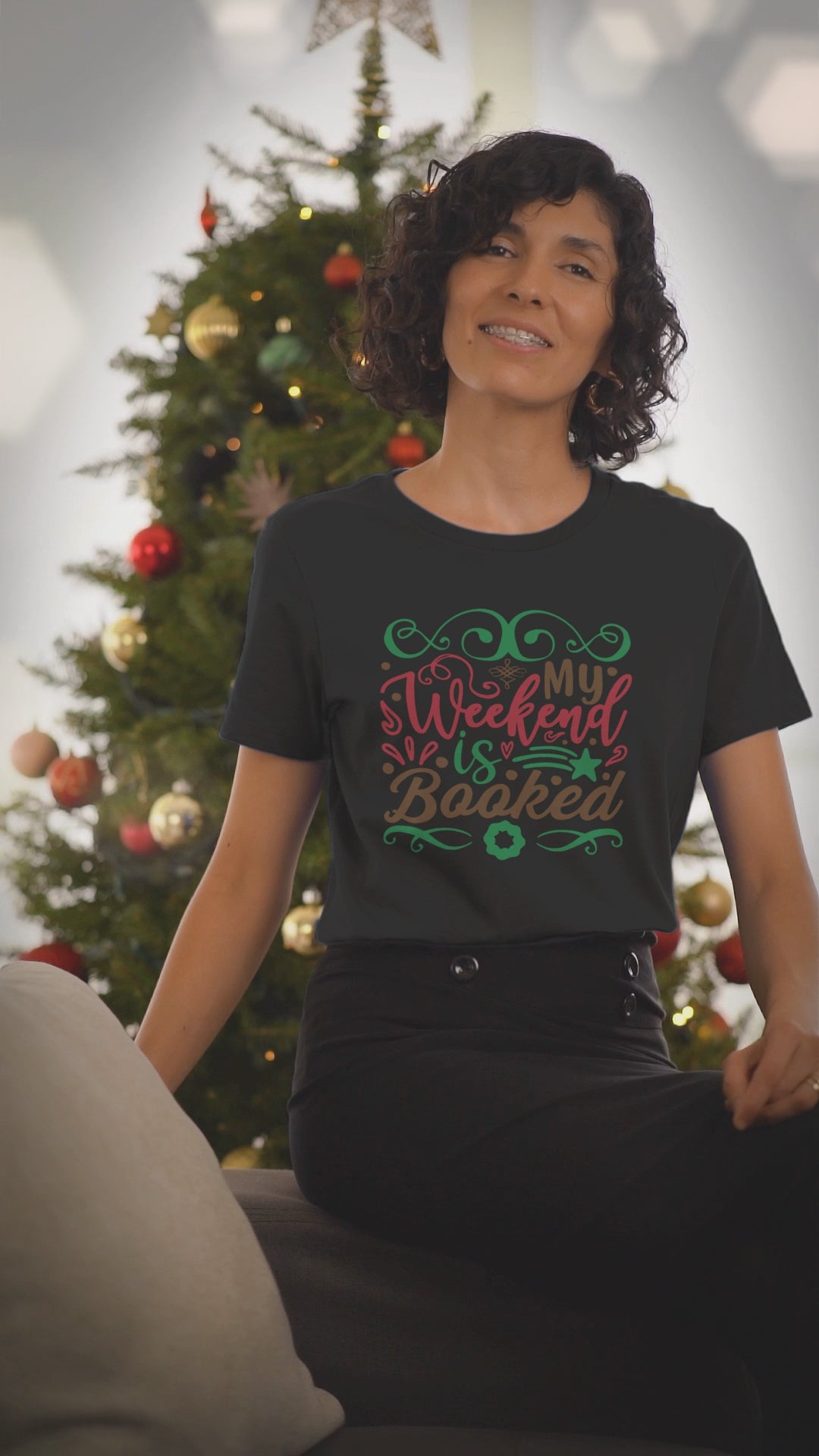 Video of a woman wearing the My Weekend Is Booked black Christmas t-shirt