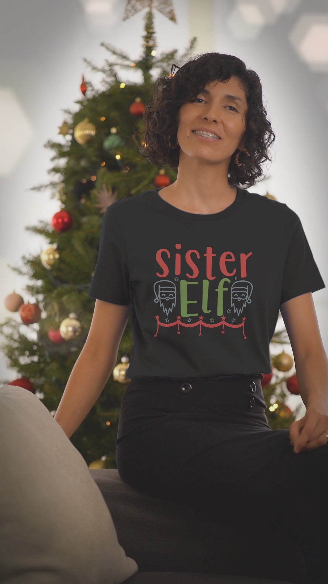 Video of a woman wearing the Sister Elf black Christmas t-shirt